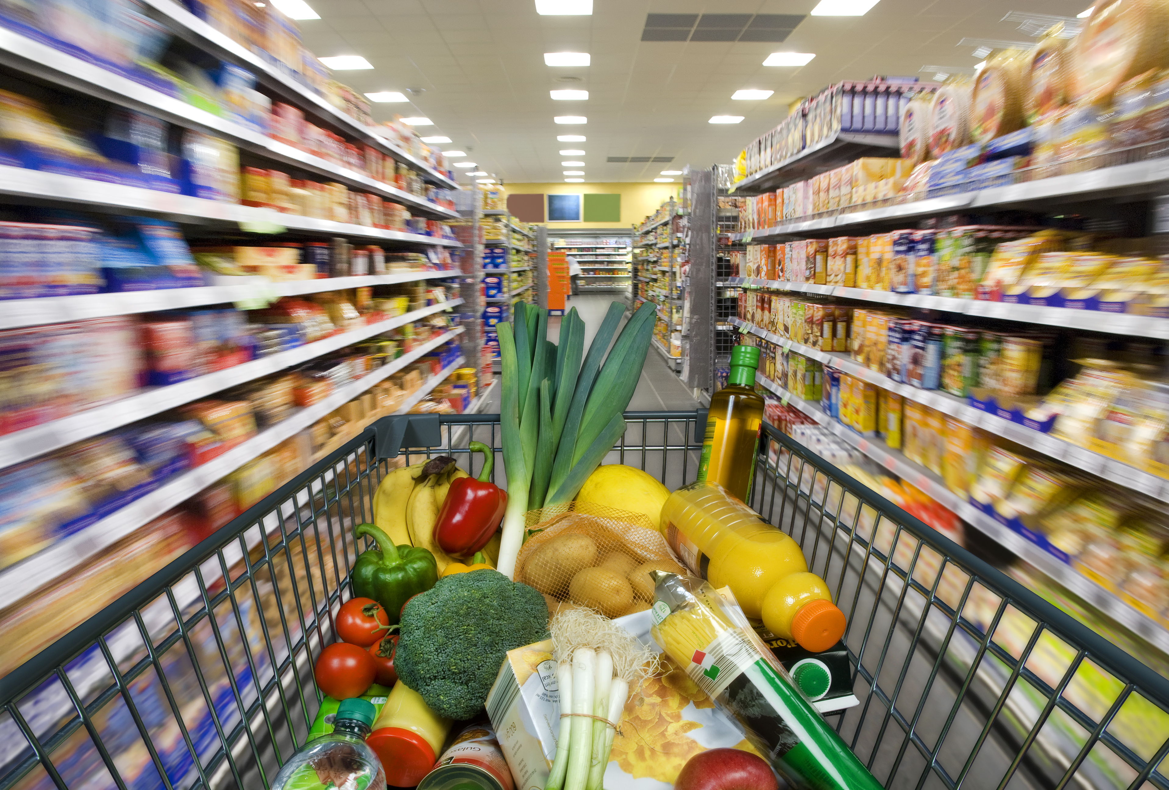Shopping cart with foods at the grocery store